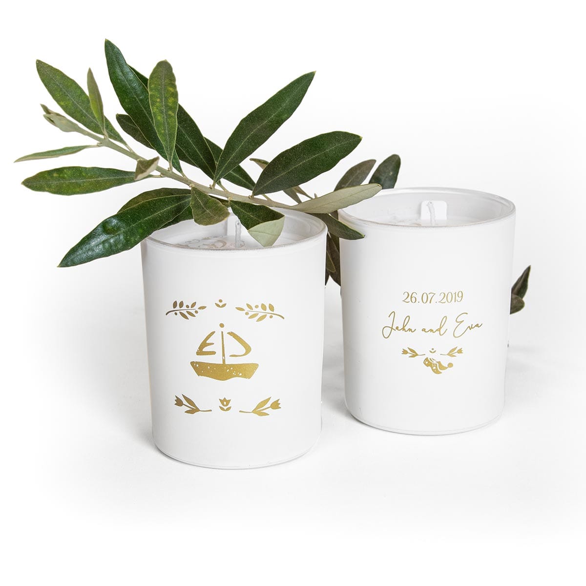 Λευκά κεράκια με σχέδια και πράσινα φύλλα.