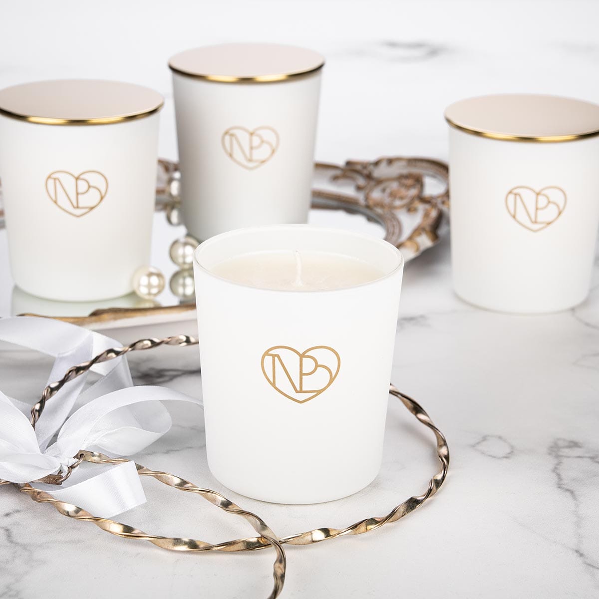 Άσπρα αρωματικά κεριά σε μαρμάρινο φόντο.