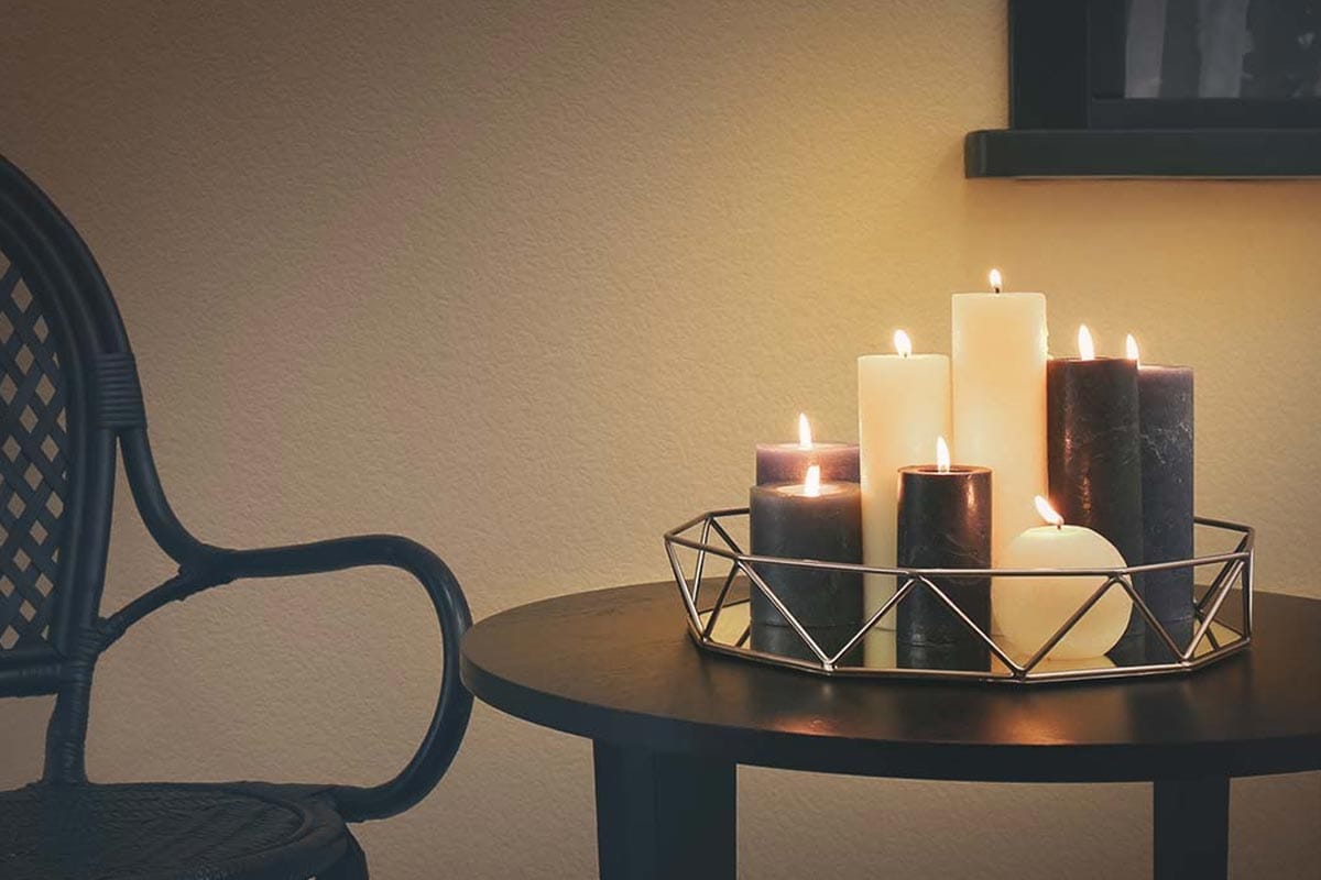 Φωτισμένα κεριά σε διακοσμητικό δίσκο στο τραπέζι.