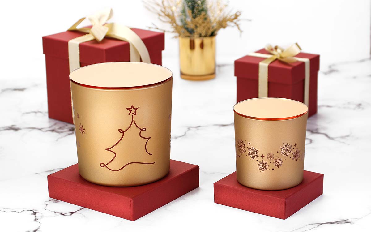 Πολυτελές σετ αρωματικών κεριών Nancy's Candles σε χρυσό περλέ γυαλί με γιορτινή εκτύπωση για την DAMCO ENERGY.